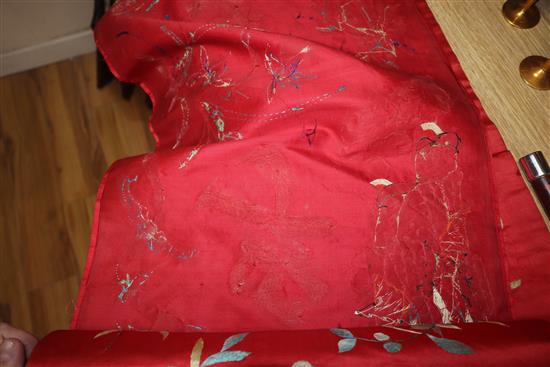 A Chinese red silk banner embroidered with figures, flowers, insects and calligraphy,